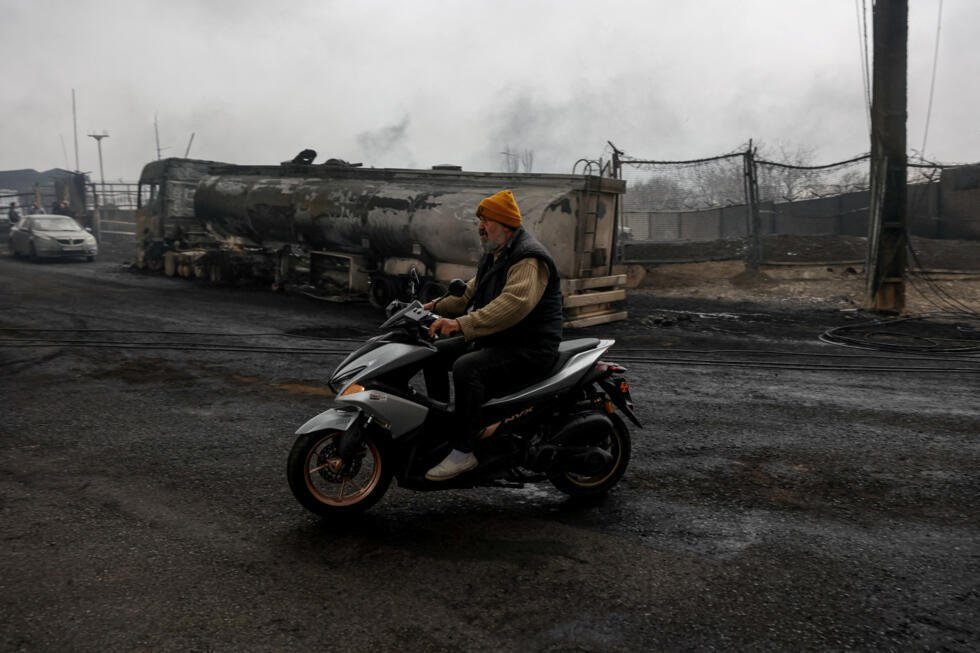 Un hombre conduce una motocicleta, tras un supuesto ataque contra los depósitos de combustible de Shahran, en medio del conflicto entre Estados Unidos e Israel con Irán, en Teherán, Irán, el 8 de marzo de 2026.