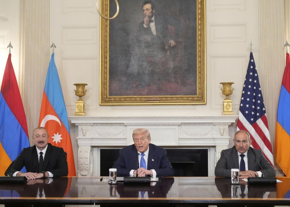 President Donald Trump, center, sits during a trilateral signing with Azerbaijan's President Ilham Aliyev, left, and Armenia's Prime Minister Nikol Pashinyan in the State Dining Room of the White Hous